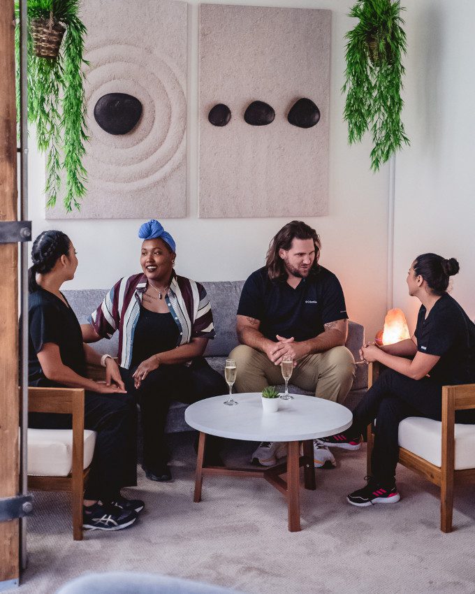 A group of massage therapists sitting while chatting with each other