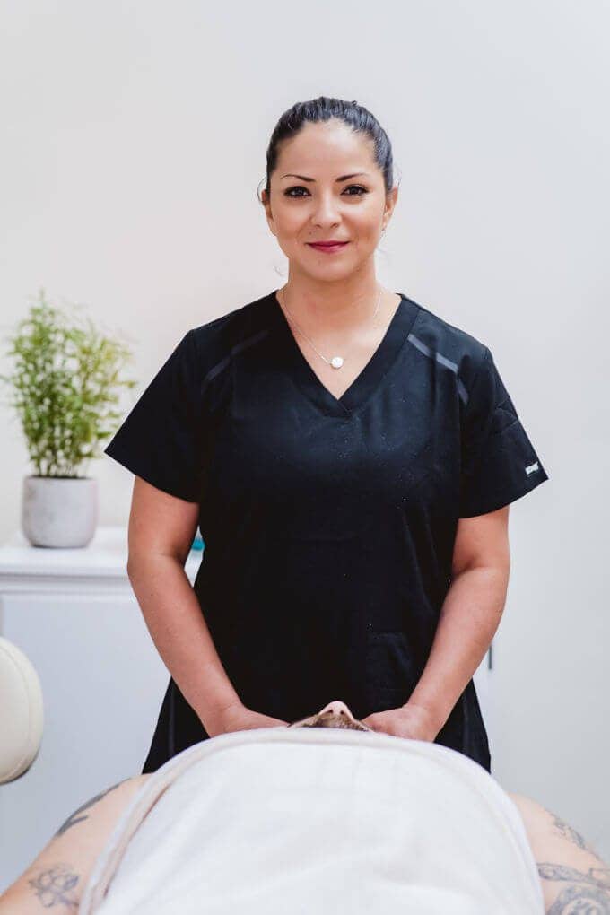 A female massage therapist smiling