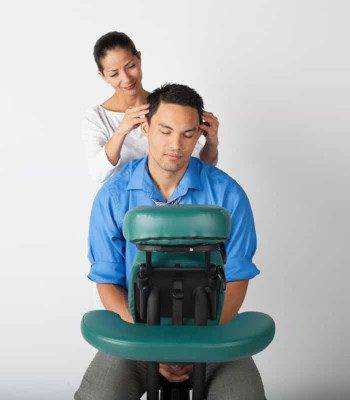 Denver Chair Massage at Zend Out Massage Spa A man getting an in-office chair massage.