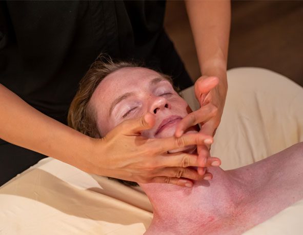 zendout-expnc A man receiving a massage on his face by a therapist