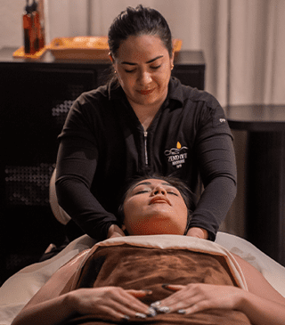 Single massge A woman relaxing while receiving a single massage hot stone treatment on her back.