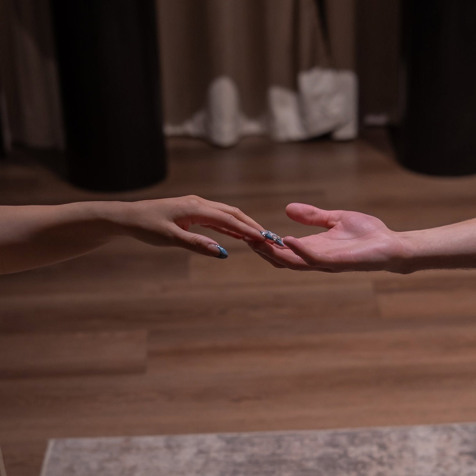 Two partners reaching for each other's hands in a Zen'd Out suite