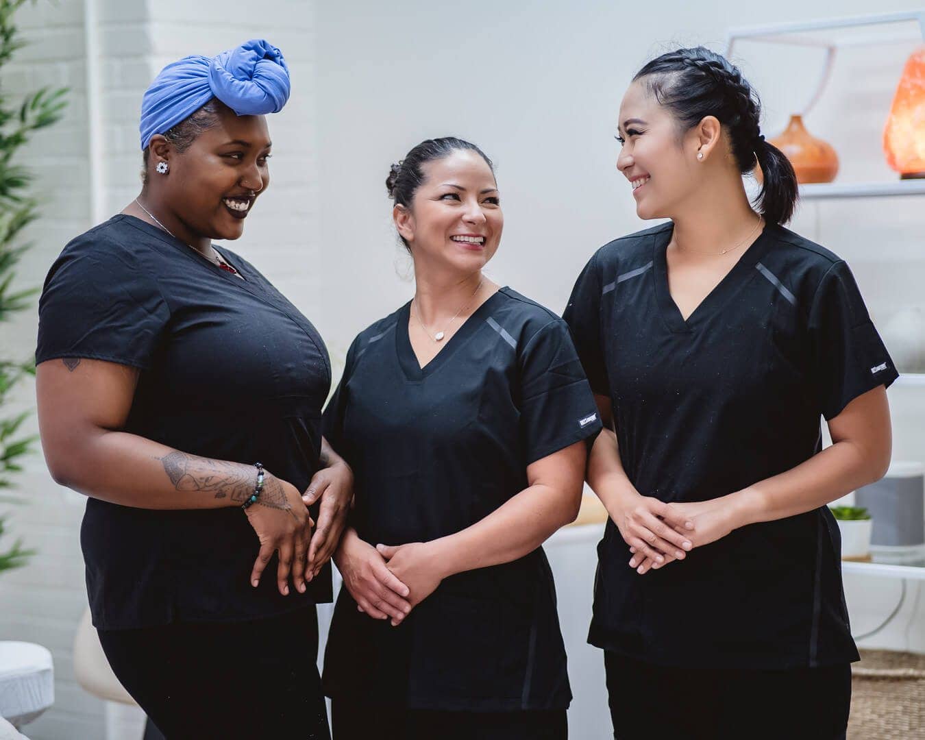 Three Zen'd Out massage therapists standing together