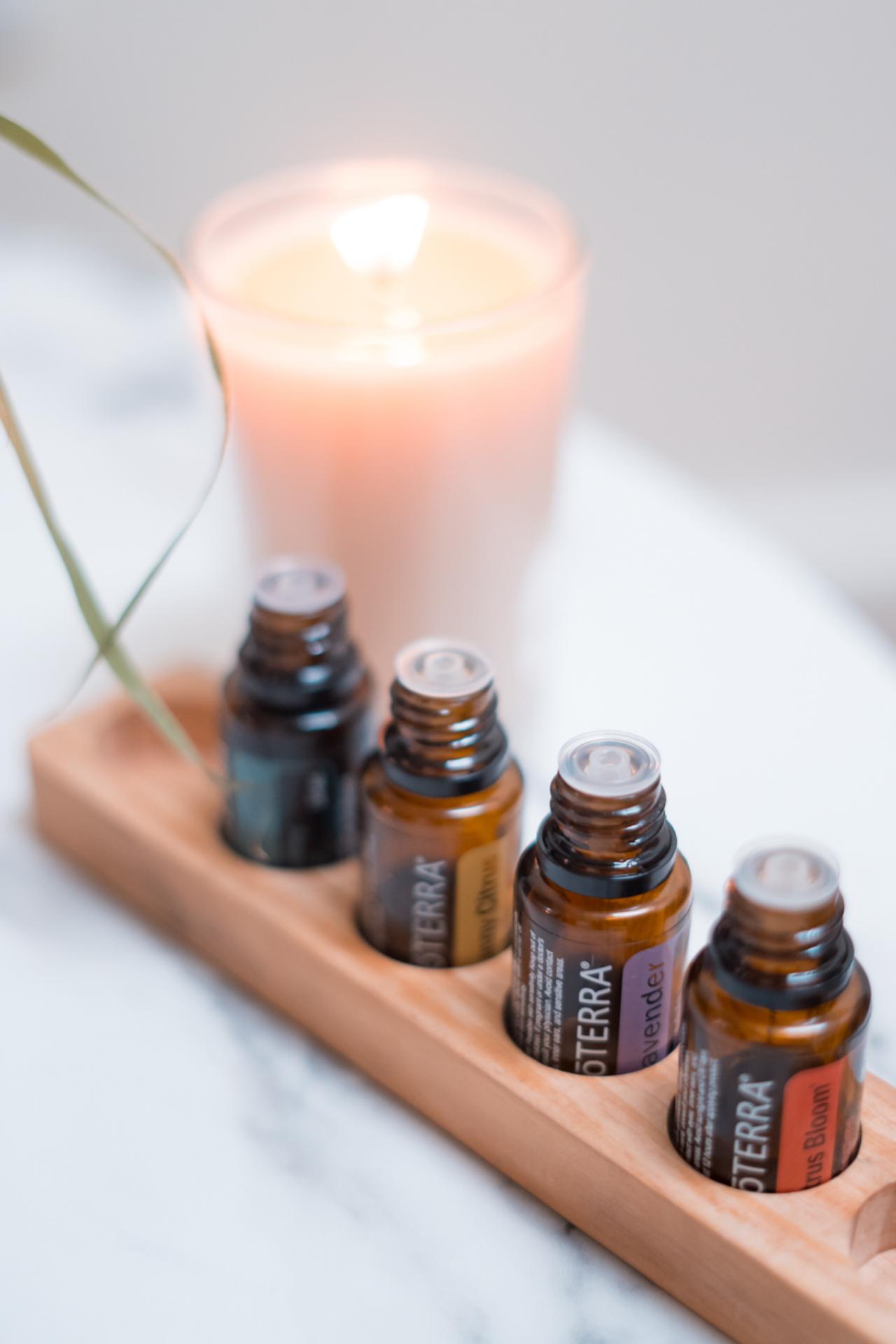 Aromatherapy oils and a candle arranged at Zen'd Out